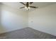 This bedroom features carpet flooring and a ceiling fan at 8370 W Audrey Ln, Peoria, AZ 85382