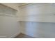 Walk-in closet with carpet, ample shelving and rods for hanging clothes at 8370 W Audrey Ln, Peoria, AZ 85382