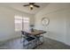 Cozy dining room features modern decor, a stylish ceiling fan, and a window view at 8370 W Audrey Ln, Peoria, AZ 85382