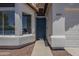 Close-up of the front entrance featuring a security door and well-kept landscaping at 8370 W Audrey Ln, Peoria, AZ 85382