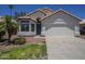 Charming single-Gathering home with a two-car garage and well-maintained front yard at 8370 W Audrey Ln, Peoria, AZ 85382