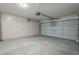 Spacious garage with storage cabinets and an automatic door at 8370 W Audrey Ln, Peoria, AZ 85382