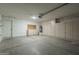 A spacious garage with lots of cabinets and concrete flooring at 8370 W Audrey Ln, Peoria, AZ 85382