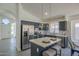 Modern kitchen with stainless steel appliances, marble countertops, and stylish pendant lighting at 8370 W Audrey Ln, Peoria, AZ 85382