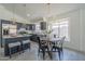 Open kitchen and dining area with stylish gray cabinetry, stainless steel appliances, and pendant lighting at 8370 W Audrey Ln, Peoria, AZ 85382