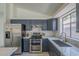 Bright modern kitchen with stainless steel appliances and white marble countertops at 8370 W Audrey Ln, Peoria, AZ 85382