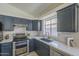 Bright modern kitchen with stainless steel appliances and white marble countertops at 8370 W Audrey Ln, Peoria, AZ 85382