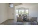 Bright living room featuring large windows, neutral tones, and stylish furniture at 8370 W Audrey Ln, Peoria, AZ 85382