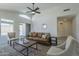 Bright living room featuring neutral paint, stylish furniture, and views of the outdoor pool area at 8370 W Audrey Ln, Peoria, AZ 85382