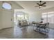 Open-concept living and dining area with tile floors and plenty of natural light at 8370 W Audrey Ln, Peoria, AZ 85382