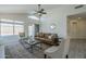 Inviting living room with high ceilings, ceiling fan, plush seating, and a view of the pool at 8370 W Audrey Ln, Peoria, AZ 85382