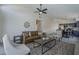 Spacious living room with a fireplace, high ceilings, and open access to the kitchen and dining areas at 8370 W Audrey Ln, Peoria, AZ 85382