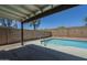 A backyard swimming pool with an adjacent covered patio area at 8370 W Audrey Ln, Peoria, AZ 85382