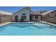 Swimming pool next to home with patio, inviting homeowners to unwind outdoors at 8370 W Audrey Ln, Peoria, AZ 85382