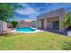 Backyard featuring a pool, grassy area, and covered patio, creating an ideal outdoor retreat at 866 W Geronimo St, Chandler, AZ 85225