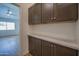 Hallway with storage cabinets, quartz counters and wood-look floors at 866 W Geronimo St, Chandler, AZ 85225