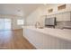 Modern kitchen featuring a large island, stainless steel appliances, and wood-style flooring at 866 W Geronimo St, Chandler, AZ 85225