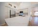 Bright kitchen features stainless steel appliances, white cabinetry, and a large center island with quartz countertops at 866 W Geronimo St, Chandler, AZ 85225