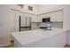 Updated kitchen with white cabinetry, stainless steel appliances, and quartz countertops at 866 W Geronimo St, Chandler, AZ 85225