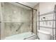 Well-lit bathroom featuring a shower-over-tub with glass doors and modern hardware at 8787 E Mountain View Rd # 1087, Scottsdale, AZ 85258
