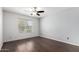 Bright bedroom with hardwood floors, a ceiling fan, and a large window at 8787 E Mountain View Rd # 1087, Scottsdale, AZ 85258