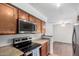 Bright kitchen showcasing granite countertops, stainless steel microwave and view to living room at 8787 E Mountain View Rd # 1087, Scottsdale, AZ 85258