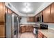 Well-lit kitchen featuring stainless steel appliances, stone countertops, and light brown wooden cabinets at 8787 E Mountain View Rd # 1087, Scottsdale, AZ 85258
