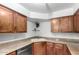 Granite countertop in kitchen featuring white sink and modern dishwasher at 8787 E Mountain View Rd # 1087, Scottsdale, AZ 85258