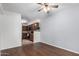 Wood flooring in living room featuring ceiling fan and kitchen view at 8787 E Mountain View Rd # 1087, Scottsdale, AZ 85258