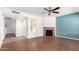 Modern living room with wood floors, cozy fireplace, and serene blue accent wall at 8787 E Mountain View Rd # 1087, Scottsdale, AZ 85258