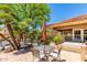 Charming outdoor patio with table and chairs, shaded by lush trees, ideal for relaxing and enjoying the beautiful weather at 8787 E Mountain View Rd # 1087, Scottsdale, AZ 85258