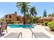 Gorgeous community swimming pool and hot tub surrounded by lounge chairs, palm trees, and beautifully landscaped grounds at 8787 E Mountain View Rd # 1087, Scottsdale, AZ 85258
