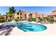 Gorgeous community swimming pool and hot tub surrounded by lounge chairs, palm trees, and beautifully landscaped grounds at 8787 E Mountain View Rd # 1087, Scottsdale, AZ 85258