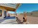 Low maintenance backyard with decorative chimney, a gravel landscape, and shade from a covered patio at 884 W 15Th Ave, Apache Junction, AZ 85120