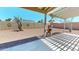Backyard with a graveled landscape, covered patio, and a view of solar panels on the back of a home at 884 W 15Th Ave, Apache Junction, AZ 85120