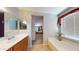Bright bathroom featuring dual vanities, soaking tub, and a glimpse into the adjacent bedroom suite at 884 W 15Th Ave, Apache Junction, AZ 85120