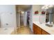 Bathroom featuring dual sinks, a glass-enclosed shower, and stylish tile flooring at 884 W 15Th Ave, Apache Junction, AZ 85120