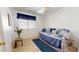 Cozy bedroom featuring a daybed with blue accents and a window with natural light at 884 W 15Th Ave, Apache Junction, AZ 85120