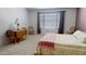 Inviting bedroom featuring soft carpet, a cozy bed, and a charming desk area at 884 W 15Th Ave, Apache Junction, AZ 85120