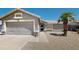 Charming single-story home featuring a two-car garage, desert landscaping, and a cozy front porch at 884 W 15Th Ave, Apache Junction, AZ 85120