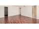 Bedroom with wood floors and neutral walls features a walk-in closet and access to the bathroom at 927 E Charleston Ave, Phoenix, AZ 85022