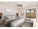 Serene bedroom with a comfortable bed, stylish decor, and sliding glass doors to the patio at 927 E Charleston Ave, Phoenix, AZ 85022