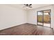 Bright bedroom with wood floors, a ceiling fan, and sliding glass doors to the outdoor patio at 927 E Charleston Ave, Phoenix, AZ 85022