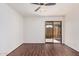 Bright bedroom featuring wood floors, ceiling fan, and sliding glass doors to the backyard at 927 E Charleston Ave, Phoenix, AZ 85022