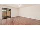 Sunny bedroom with wood floors and sliding glass doors to the patio at 927 E Charleston Ave, Phoenix, AZ 85022