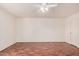 Bedroom with wood floors and neutral walls features a ceiling fan and a door to the hallway at 927 E Charleston Ave, Phoenix, AZ 85022
