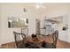 Cozy dining area adjacent to the kitchen, featuring a round table and a view of the bathroom at 927 E Charleston Ave, Phoenix, AZ 85022