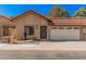Charming single-story home featuring a red tile roof, a two-car garage, and a well-maintained front yard at 927 E Charleston Ave, Phoenix, AZ 85022