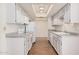 Bright kitchen with wood floors, recessed lighting, light gray cabinets and white appliances at 927 E Charleston Ave, Phoenix, AZ 85022
