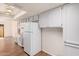 Bright kitchen with wood floors, recessed lighting, light gray cabinets and white refrigerator at 927 E Charleston Ave, Phoenix, AZ 85022